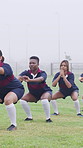 Fitness, team or people with squat on field, warm up exercise or drill for match preparation. Outdoor, rugby player or women with getting ready for game, sports workout and practice for competition