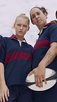 Face, women and rugby team for sports, game training and serious together at field with low angle. Portrait, confident players and athlete with ball outdoor for exercise, determination and fitness