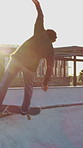 Boy, teenager and skating with skateboard outdoor for fitness, exercise and practice tricks. Back, skater and balance for stunt performance, endurance training and extreme sports for weekend activity