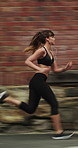 Running, music and woman in city with earphones for exercise, cardio workout and training. Runner, sports and person with active hobby for wellness, health and endurance with speed, audio and track