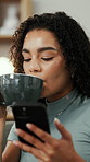 Happy, woman and drinking coffee in home with phone, social media post and relax for weekend break. Person, smile and scroll in living room with warm tea, wellness and tech for reading online news.