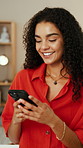 Woman, smile and typing in home with phone, text message or email notification for remote work project. Happy, female person and scroll in house with tech, mobile app and good news for freelance job.