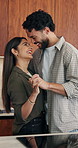 Dance, love and couple holding hands in kitchen for connection, relationship and smile. Happiness, bonding and woman with partner for dancing, rhythm and movement with romance, music and home