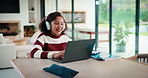 Laptop, headphones and child on video call in house for elearning, online class or education. Paper, happy and girl student with audio tech and computer for virtual lesson with homework in apartment.