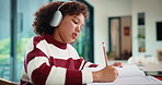 Child, writing and headphones in house with homework, music playlist or problem solving for education. Girl, notes or thinking in home with audio tech, streaming song or learning for knowledge growth