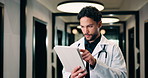 Tablet, doctor and typing in hospital for healthcare, review report or patient history. Smile, man and medical worker with digital tech for telehealth, insurance records and schedule in clinic