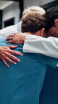 Huddle, team and doctors with nurses in hospital for solidarity, unity and collaboration. Hug, achievement and group of healthcare employees with support circle, celebration or goals in clinic.