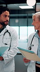 Folder, doctors and discussion in hospital for medical advice, planning surgery or treatment plan. Diagnosis, solution and healthcare people walking, talking and update on clinic results or test