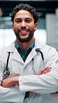 Crossed arms, man and face of doctor in hospital with confidence for career in medical service. Smile, professional and portrait of male healthcare worker with pride for about us at clinic in Cuba.