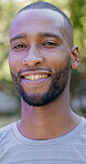 Outdoor, face or black man with confidence for fitness, cardio training or morning routine for health. Portrait, bokeh  and runner in park for endurance practice, smile and pride for wellness goals