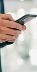 Hands, phone and typing with person in office for alert, communication or notification. App, contact or update with business employee on digital tech for internet search, management or text message