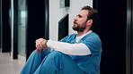 Healthcare, surgeon and man with burnout in hospital, overwhelmed and thinking of difficult surgery. Unhappy, doctor and person with fatigue after medical operation, reflection or exhausted in clinic