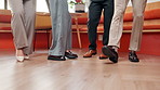 Legs, business people and dance in office for celebration, success or financial achievement. Shoes, team and moving to music in workplace for investment milestone, win or company target at party