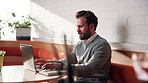 Businessman, typing or remote work in cafe with laptop, online report or research for insurance agency. Contract worker, person and browse in restaurant with computer, risk assessment or policy cover
