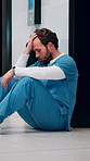 Stress, doctor and man with mistake in hospital for patient loss, surgery fail and crisis. Healthcare, thinking and person with worry, guilt and regret on floor for medical service, burnout and error