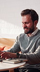 Typing, happy and businessman in cafe with remote work for finance report with research for budget. Smile, computer and financial manager with freelance career for investment proposal in coffee shop.