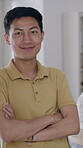 Face, man and happy with arms crossed in office creative internship, career development and pride. Marketing intern, asian person and smile at startup for growth opportunity, about us and confidence