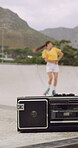 Blur, rollerskate and woman in park with radio for skating, hobby and dance on summer weekend. Skater, retro and person with music for practice, sports and spin for skills, activity and trick outdoor