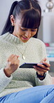 Phone, win and teenage girl in home with internet connection, celebration and app online. Excited person, fist pump or technology with success for website search, gaming prize or relax in house