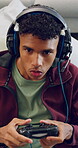 Gaming, controller and boy with headset in home, virtual contest and play online for entertainment. Digital world, child and teenager with tech for video game competition, concentration and challenge