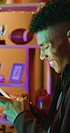 Phone, smile and teenage boy in home with internet connection, social media post and app online. Happy person, neon light or technology with scroll for website search, gaming or relax in house