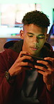 Gaming, phone and man in home for streaming service, esports app and connection. Cyber sports, subscription and entertainment with teenager in living room of house for online contest or tournament