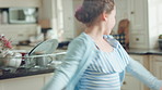 Child, dancing and fun in home kitchen with energy, childhood and spin in dress with wellness. Girl kid, happy dancer and freedom with development, play and growth with movement in family house