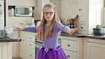 Dancing, child and girl with tutu in kitchen at home, steps rehearsal and coordination development. Weekend fun, childhood and ballerina with music for movement, energy and practice in apartment