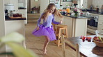 Fun, dancing and child with spin in kitchen for ballet practice, creative energy or development. Girl kid, ballerina and movement with tutu in home for performance rehearsal, learning steps or growth