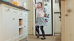 Dancing, home and child in kitchen with spinning, rhythm or creative performance with music. Wand, groove and girl kid moving to radio or playlist with energy, growth and development in house.
