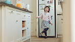 Ballet, development and energy with girl in kitchen of home for expression, fun movement or rhythm. Dance, music and steps with dancer child in apartment for balance, growth or morning practice