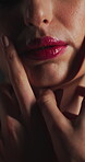 Beauty, touch and mouth with lip gloss in studio for cosmetics, self care and makeup for shine. Closeup, pink lipstick and body wellness of person with cosmetology, soft texture and shadow on skin