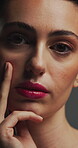 Beauty, touch and face with lip gloss in studio for cosmetics, self care and makeup for shine. Serious, pink lipstick and body wellness of person with cosmetology, soft texture and brow lamination