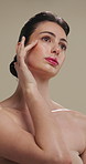 Beauty, thinking and touching with woman in studio for cosmetics or dermatology benefits. Makeup, skincare and vision with person feeling smooth skin on gray background for inspiration or planning