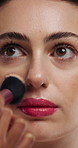 Woman, face and makeup artist with brush for beauty, cosmetics or appearance in studio. Female person, cosmetology or stylist with foundation, blemish or product for facial blush, contour or texture