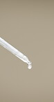 Beauty, dropper and serum on space in empty studio for cosmetics, dermatology or treatment. Drip, liquid and skincare with pipette on gray background for antiaging, cosmetology or wellness routine