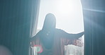 Woman, light and open with curtains in home for morning, stretching or new day in bedroom. Back view, female person or awake with fabric, flare or window for outdoor sunlight, rise and shine in house