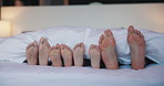 Feet, parents and children with blanket in bedroom for rest, family sleeping and calm morning. Toes, people and kids with duvet for weekend nap, comfortable and lying barefoot on cozy bedding in home