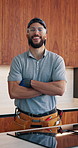 Face, man and plumber with arms crossed in home for plumbing, assessment and maintenance. Portrait, technician and smile with tools for kitchen improvement, property evaluation and repair services