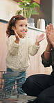 Applause, dishwasher and smile of girl with parent in home kitchen for child development or learning. Clap, loading dishes and mo, with daughter in apartment for chores, housework or responsibility