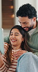 Tablet, laugh and couple on sofa in home with texting, networking or funny meme on social media. Happy, relax and man with woman on digital technology for comedy post on app in living room at house.