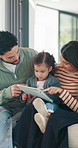 Family, bonding and girl with tablet for online games, love and entertainment in home. Happy father, mother and daughter with digital tech for cartoon, streaming or app subscription on sofa in house