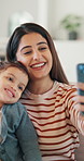 Mother, child and selfie in home with smile, bonding together and social media post for family memories. Happy, woman and toddler daughter in house with photography, support and website for mom blog.