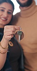 Couple, moving in and hand with key in new home, smile and property investment with partner. Happy man, woman and relocation with keychain for mortgage, future real estate and face at dream house
