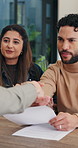 Handshake, document and couple with home meeting for advice, agreement or financial advisor. Discussion, smile and client or partner shaking hands for loan, mortgage or insurance deal with paperwork