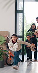 Family, moving in and running in new home, open door and excited for property investment with kids. Happy mother, father and relocation together with children, real estate or plant box in dream house