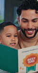 Dad, child and reading book in home for learning, growth and language development with parent. Happy father, boy or storytelling at apartment for bonding together, education or support with knowledge