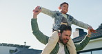 Dad, shoulder and playing with child in home for outdoor bonding, support or family time. Happy father, kid or carrying boy with smile for playful day, childhood or holiday vacation together in house