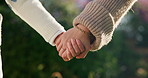 Family, mom and holding hands with child in nature for motherhood, parenting or outdoor care. Mother, kid or daughter with love, trust or commitment for protection, safety or security in garden
