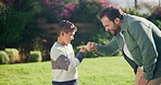Fist bump, love and smile with father and son outdoor for bonding, support and connection. Happiness, handshake and trust with man and child in backyard of family home for commitment and achievement